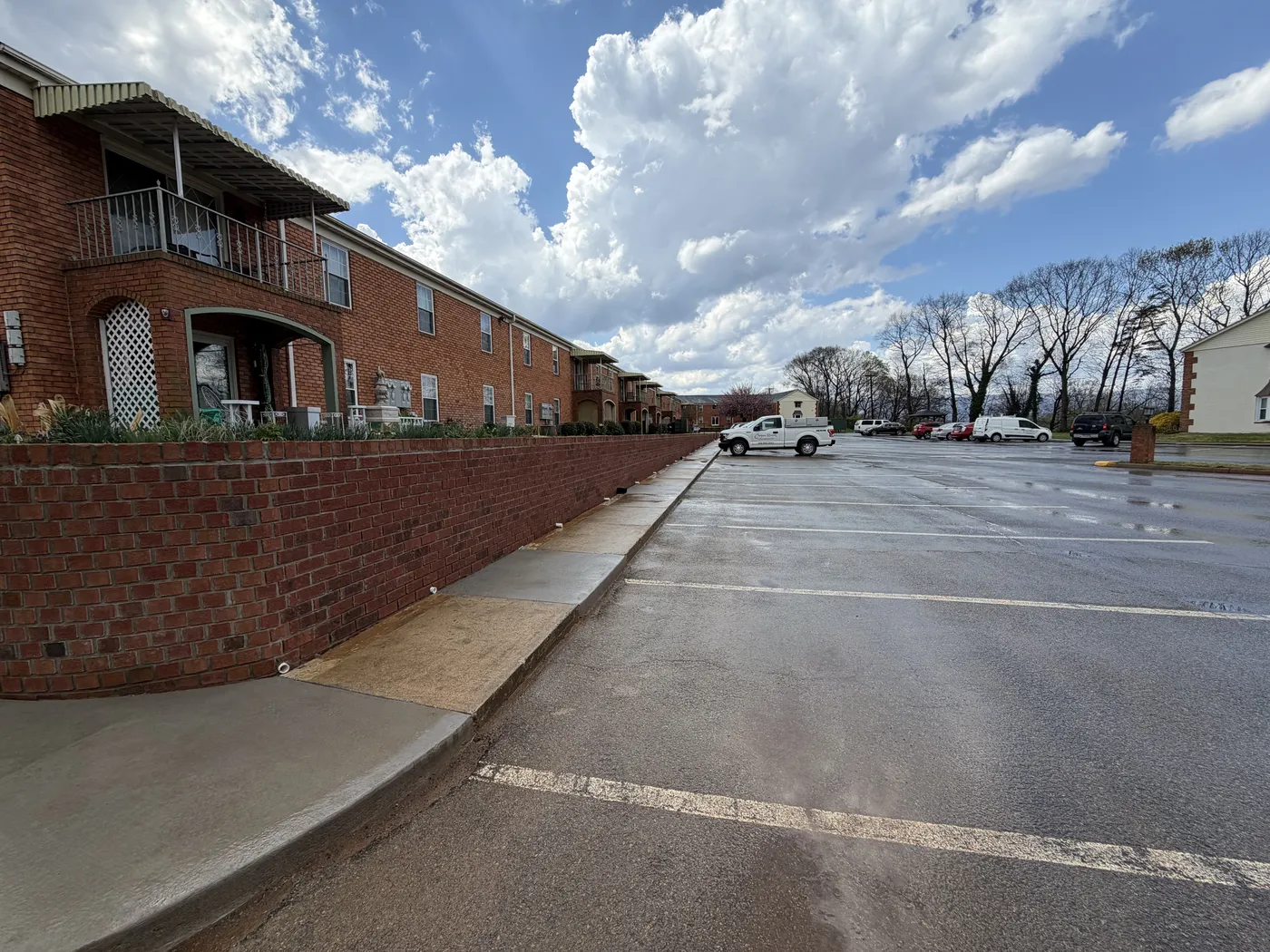 Long brick retaining wall running along apartment complex at Chateau Rivera