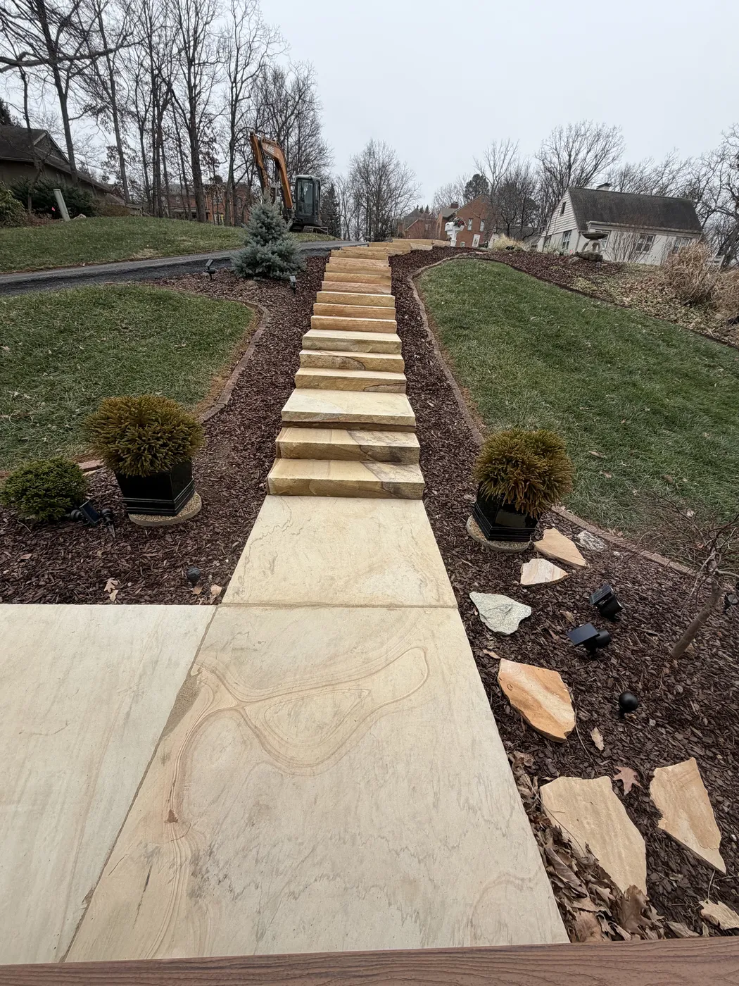 Concrete sidewalk with timber borders and mulch beds at Hunting Hill