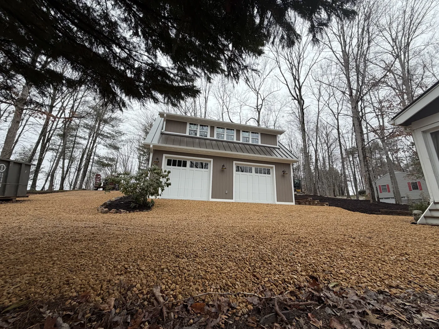 Side view of garage showing gravel area and landscape borders