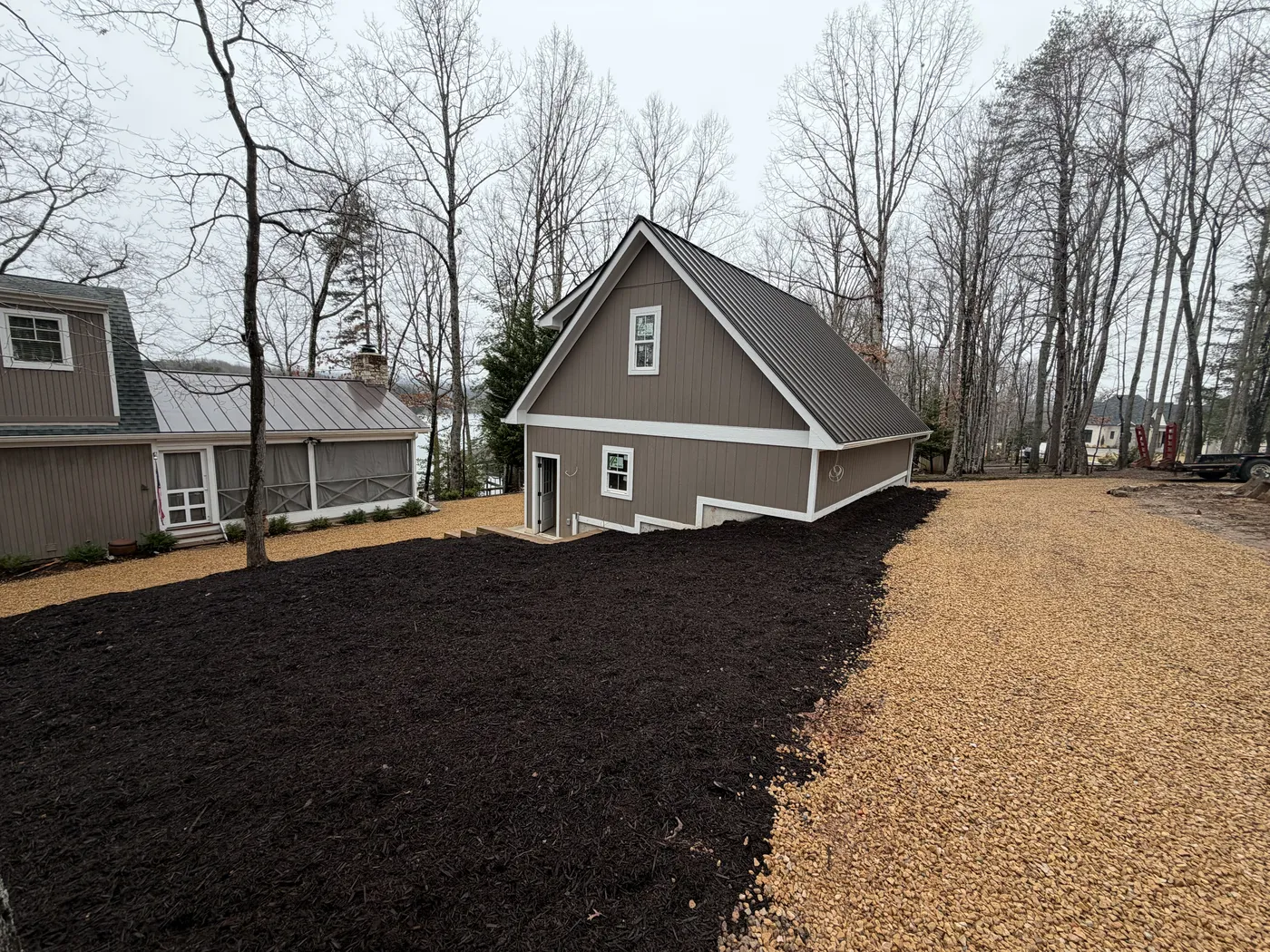 Full property view showing garage, church, and completed site work
