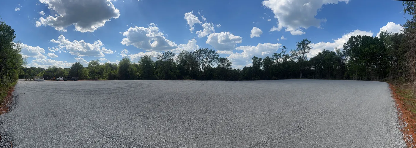 Finished lot with concrete barriers and truck visible for scale